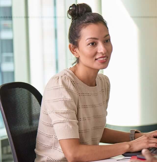 Young woman taking notes at a computer